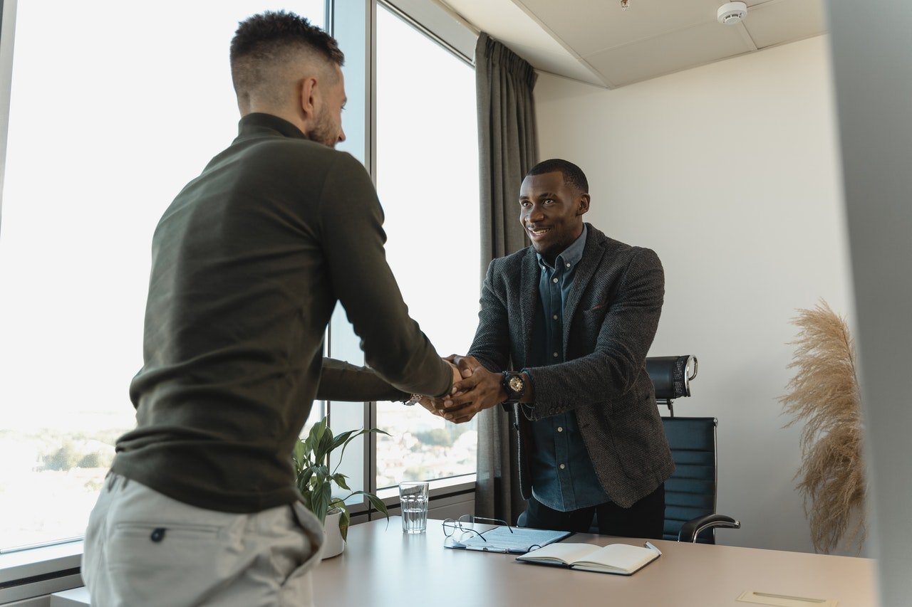 Two business man in a job interview shaking hands